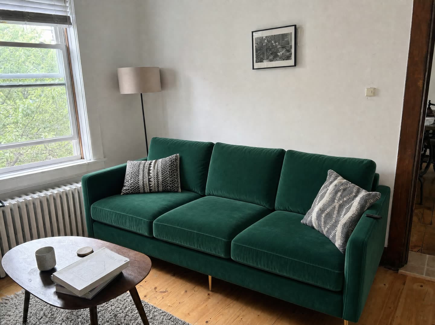 The same living room with an emerald velvet sofa