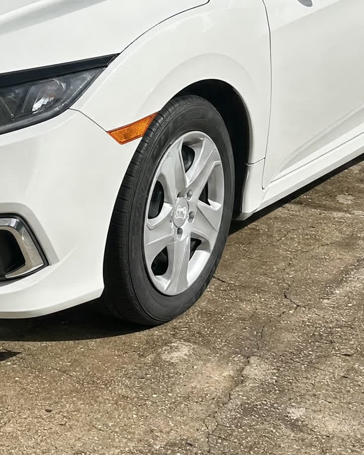 A white car's stock silver wheel